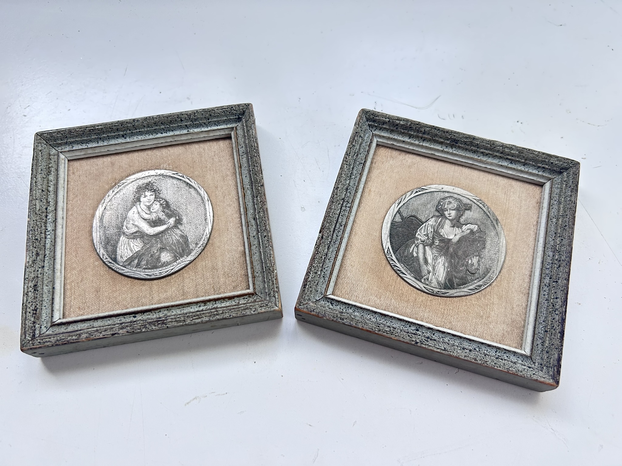 A pair of vintage pewter etched scenes mounted in matching frames, La Laitiere and Maternite