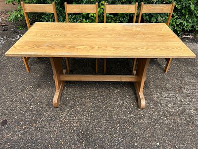 Mid century table with pegged joints supported by twin trestles and 4 accompanying Mid-Century 