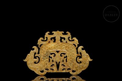 Carved jade plaque ‘Mythical Beasts’, Han style. An ornamental plaque made of ochre-coloured 