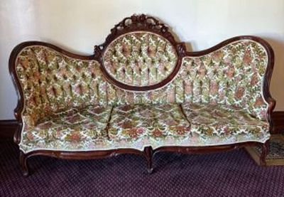 Antique Victorian-Style Settee or Parlor Sofa with a Tufted back on Ornate Hand Carved Wooden 