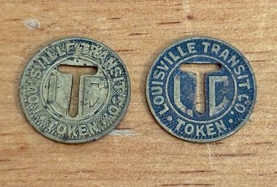 A Pair of Louisville Transit Co. Brass Fare Tokens, US .5". A pair of circular brass fare tokens 