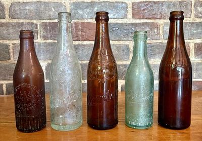 A Collection of Antique Embossed Glass Beverage Bottles from Louisville, Kentucky 2.5"X9". This 