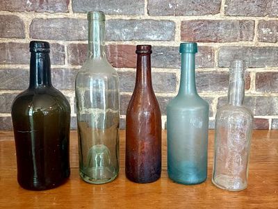 A Collection of Antique Glass Wine and Condiment Bottles 3.5"X9.5". This collection of antique 