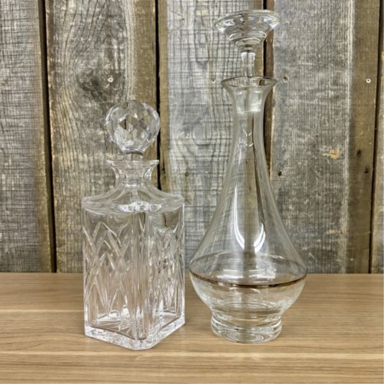 Two Glass Decanters Including a Square Cut Crystal Spirit Decanter and a Flared Decanter with Metallic Trim