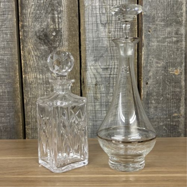 Two Glass Decanters Including a Square Cut Crystal Spirit Decanter and a Flared Decanter with Metallic Trim
