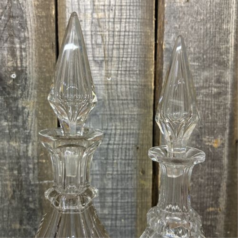 A Pair of Cut Glass Liquor Decanters with Metal Labels and Spire Stoppers