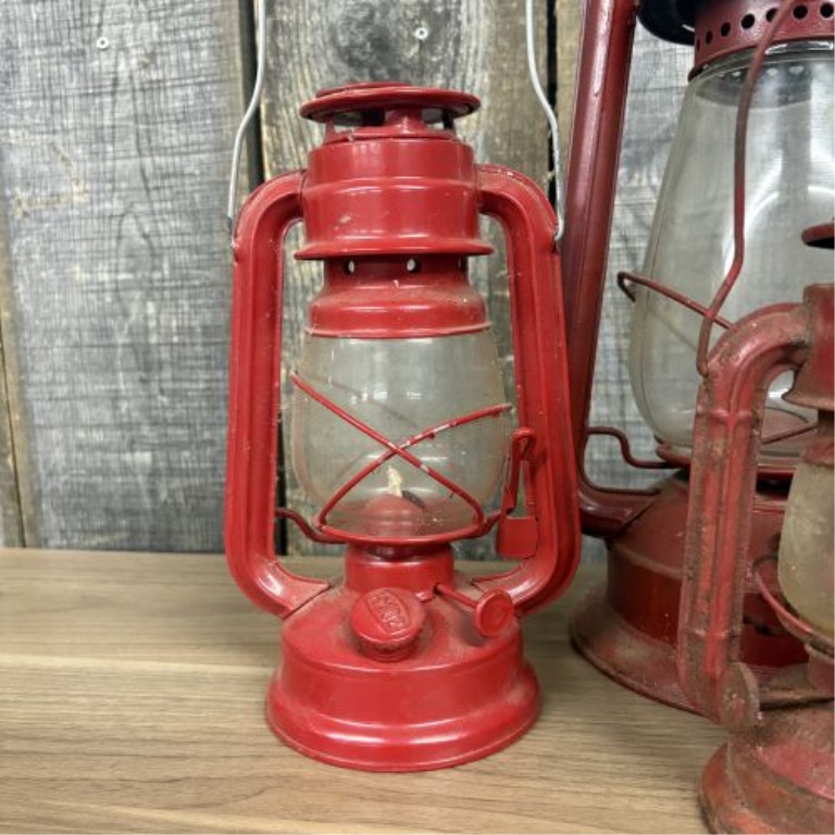 A Collection of Vintage Red Kerosene Lanterns