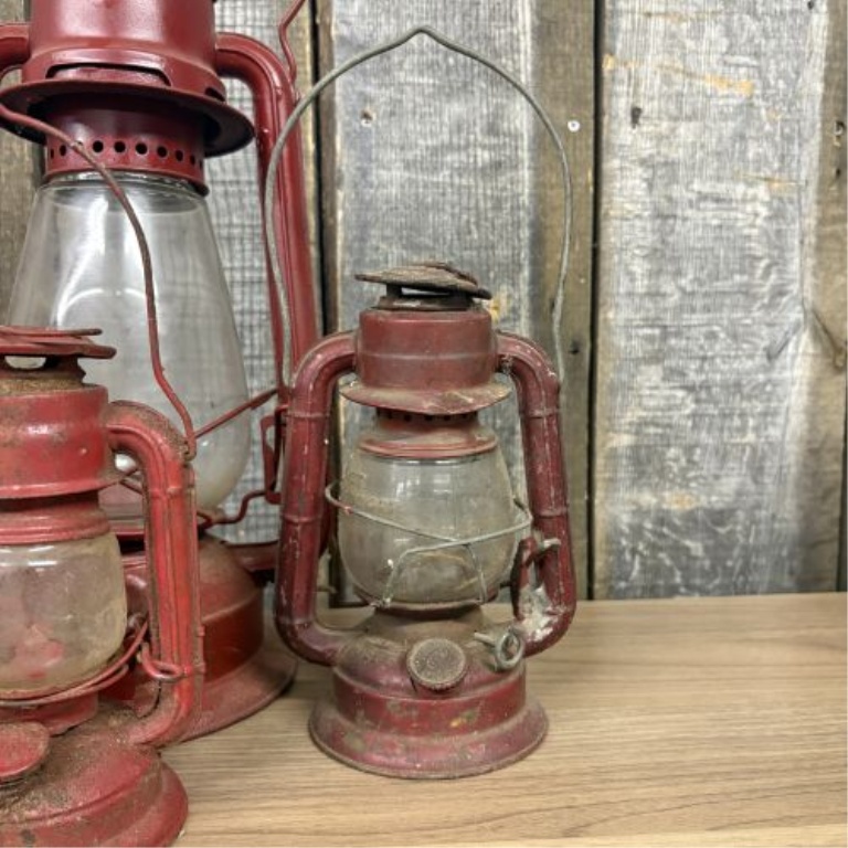 A Collection of Vintage Red Kerosene Lanterns