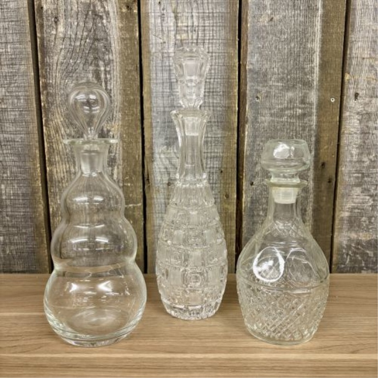 A Trio of Assorted Vintage Clear Glass Decanters