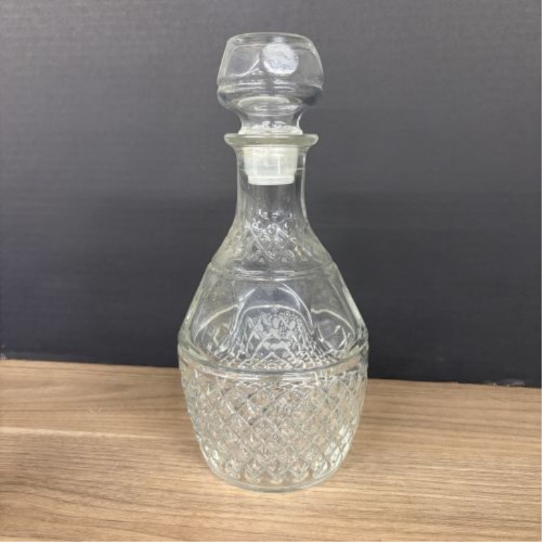 A Trio of Assorted Vintage Clear Glass Decanters