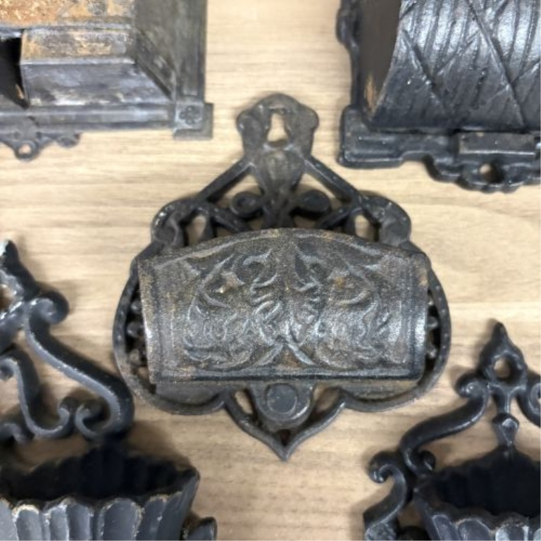 A Group of Five Victorian Cast Iron Wall Mounted Match Holders and Decorative Wall Pockets