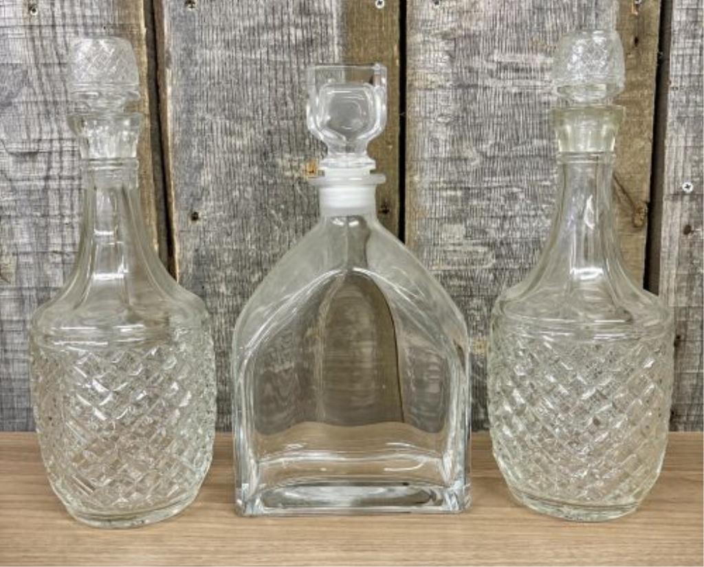 A Trio of Glass Spirit Decanters Including a Pair of Cut Glass and One Luigi Bormioli Style Example