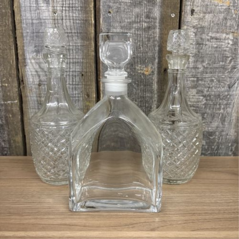 A Trio of Glass Spirit Decanters Including a Pair of Cut Glass and One Luigi Bormioli Style Example