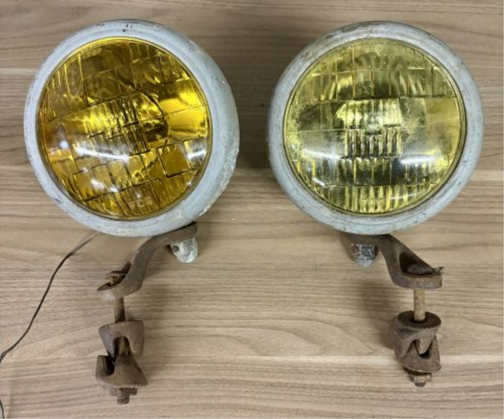 A Pair of Vintage Automotive Fog Lights with Bumper Mount Brackets