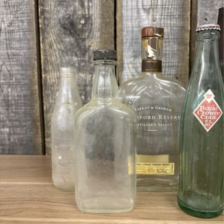 An Assortment of Vintage Glass Soda, Spirit, and Storage Containers