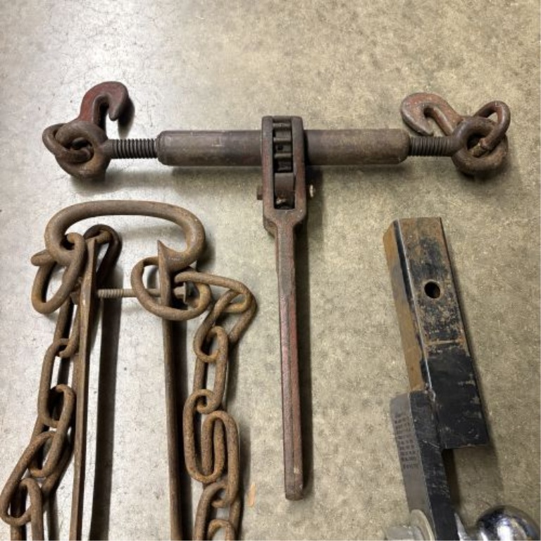 A Trio of Heavy-Duty Rigging and Towing Tools Including Ratchet Load Binder, Chain Assembly, and 2-5/16 Inch Ball Mount