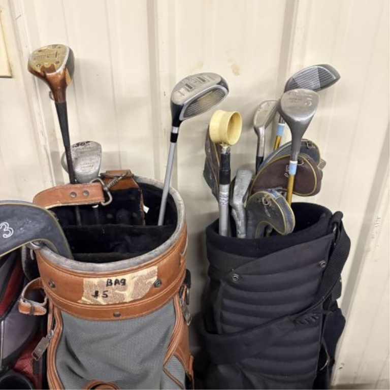 An Assortment of Golf Bags and Mixed Clubs Including Titleist and Adams Golf