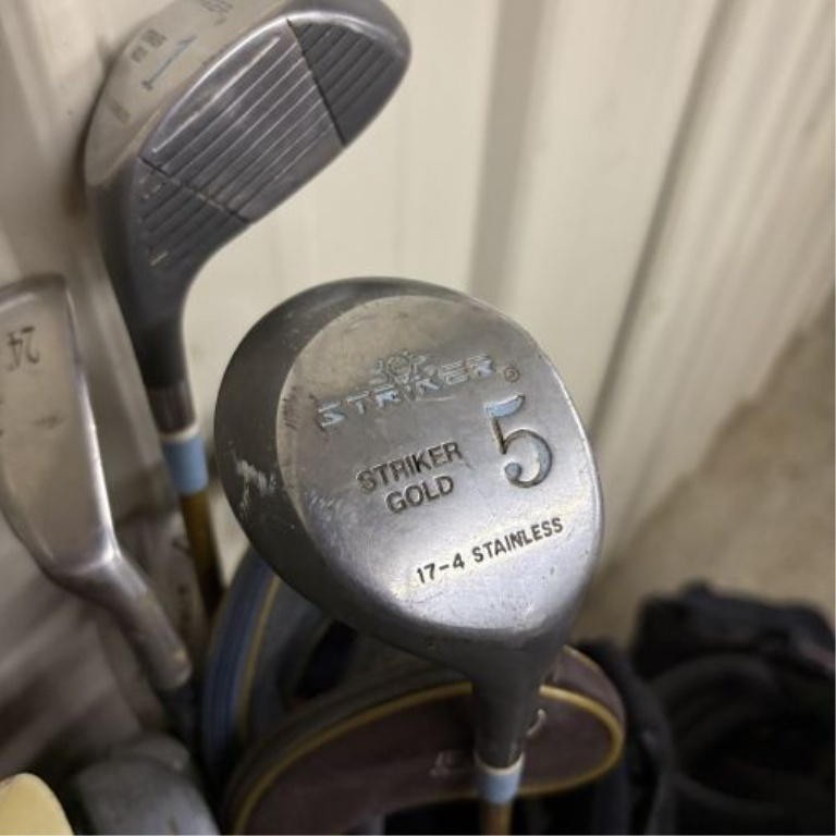 An Assortment of Golf Bags and Mixed Clubs Including Titleist and Adams Golf