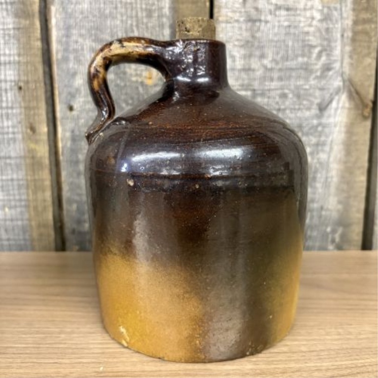 Two Pieces of American Utilitarian Stoneware Including a Two-Tone Jug and a Cylindrical Crock