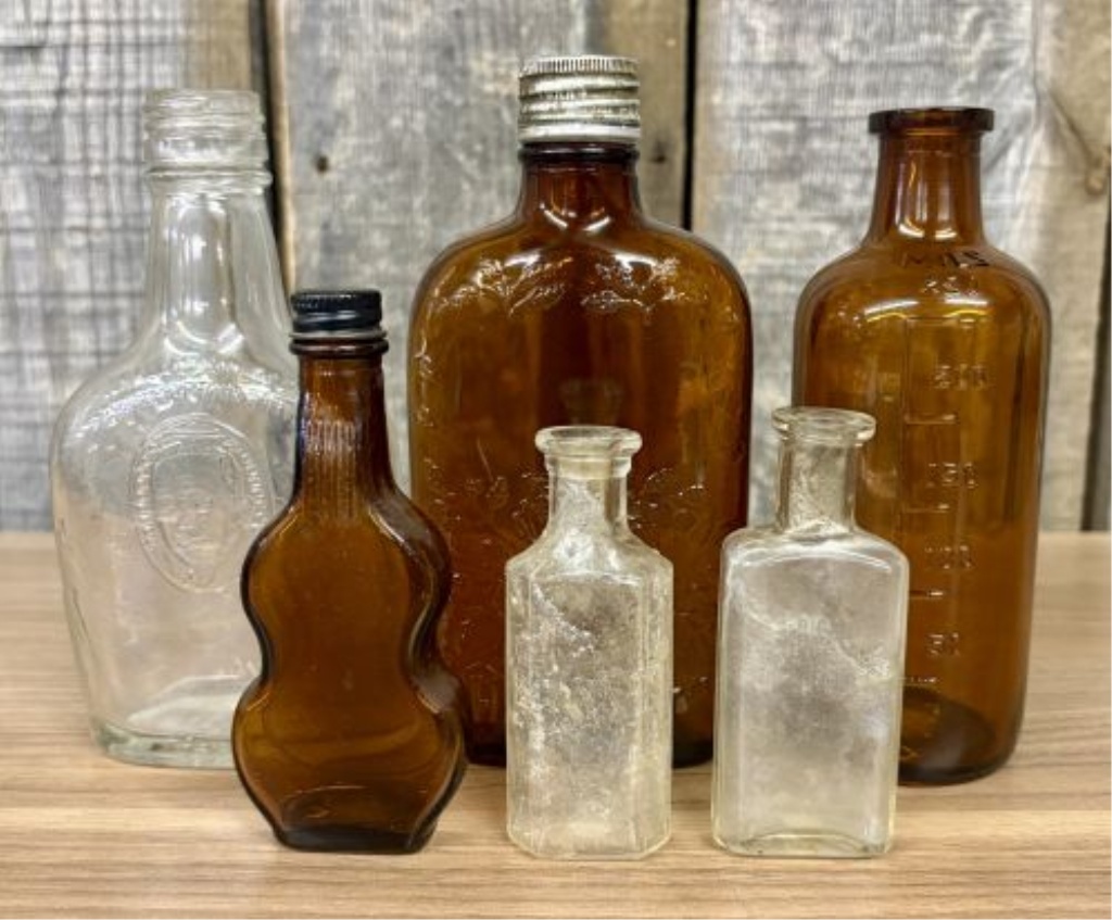 A Collection of Assorted Vintage Clear and Amber Glass Bottles