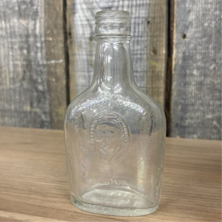 A Collection of Assorted Vintage Clear and Amber Glass Bottles