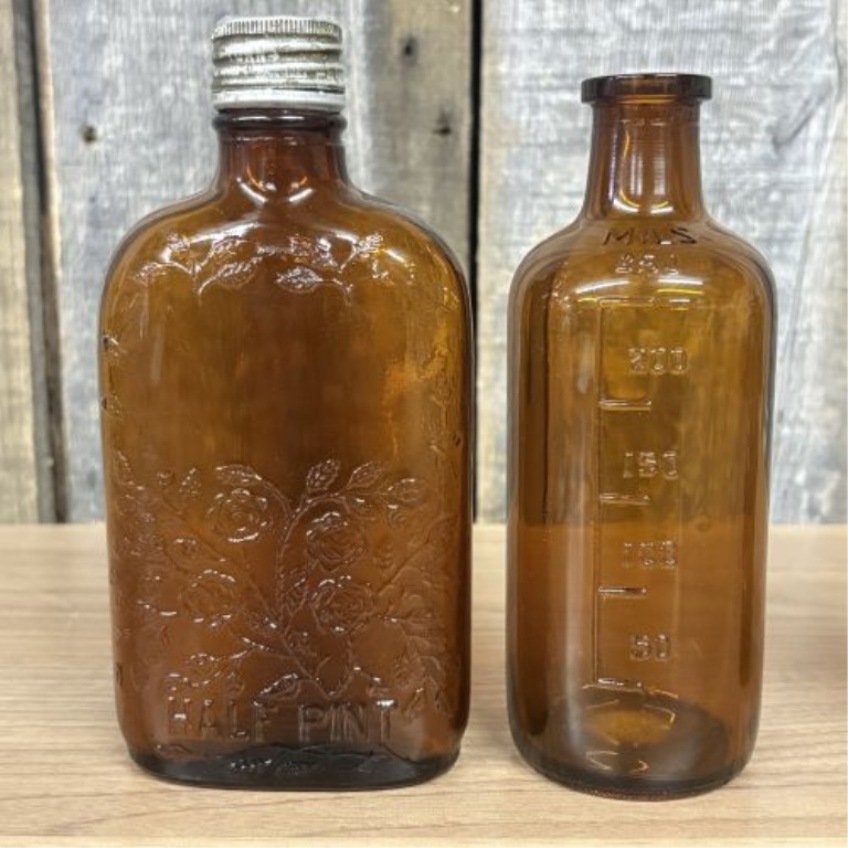 A Collection of Assorted Vintage Clear and Amber Glass Bottles
