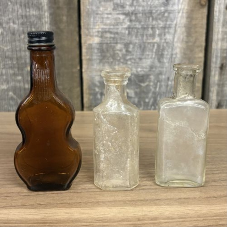 A Collection of Assorted Vintage Clear and Amber Glass Bottles