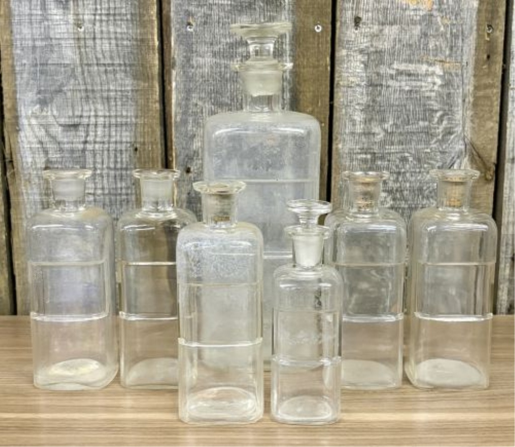 A Collection of Antique Clear Glass Apothecary Bottles Attributed to Whitall Tatum and Company