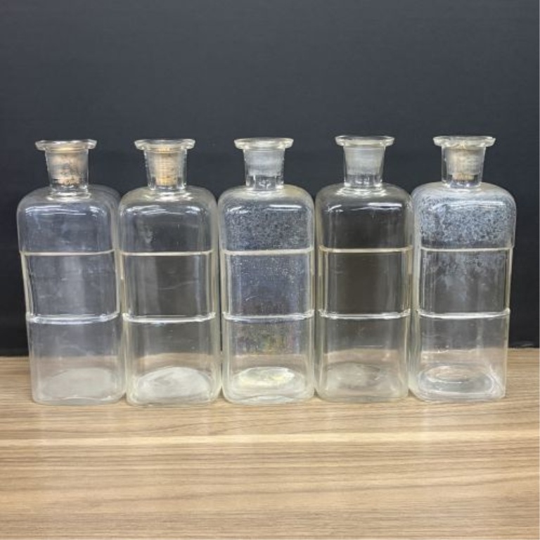 A Collection of Antique Clear Glass Apothecary Bottles Attributed to Whitall Tatum and Company