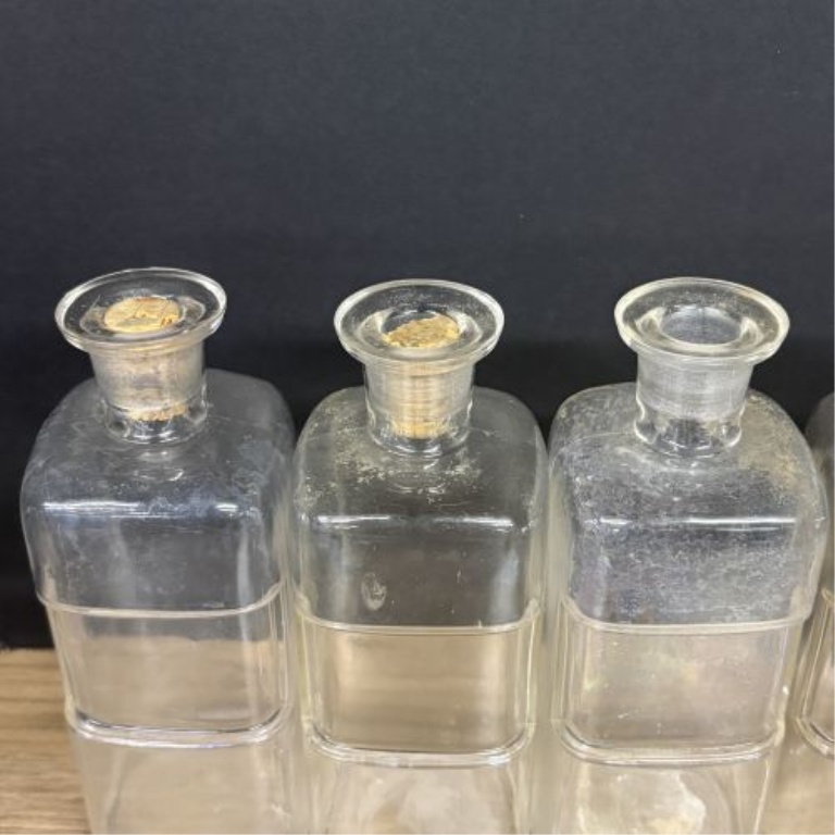A Collection of Antique Clear Glass Apothecary Bottles Attributed to Whitall Tatum and Company
