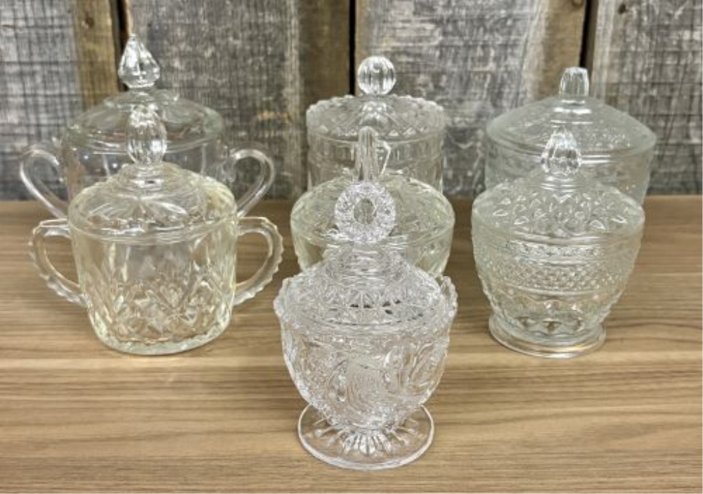 Seven Clear Glass Lidded Table Articles Including Pieces in the Style of Anchor Hocking Wexford