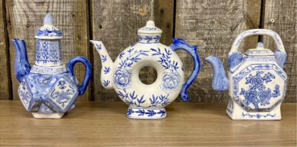 A Trio of Chinese Style Blue and White Porcelain Decorative Teapots