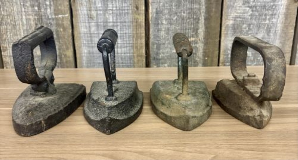 A Collection of Four Antique Cast Iron Sad Irons