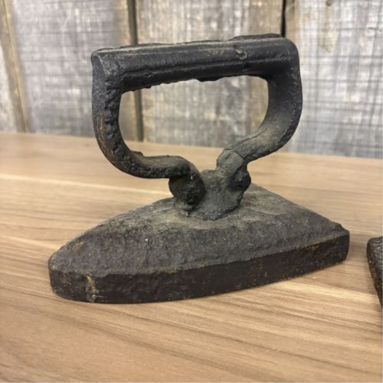 A Collection of Four Antique Cast Iron Sad Irons