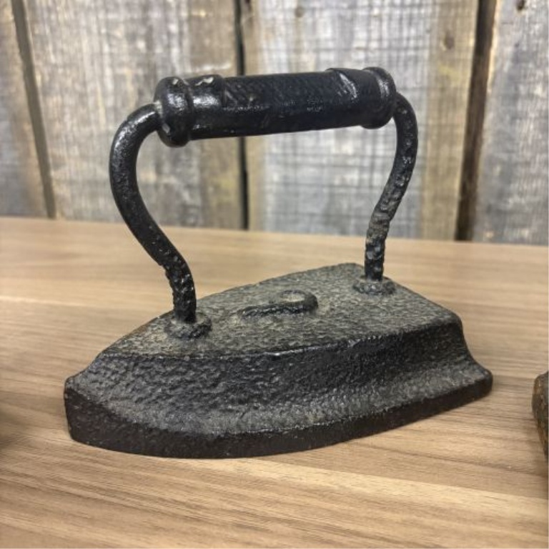 A Collection of Four Antique Cast Iron Sad Irons