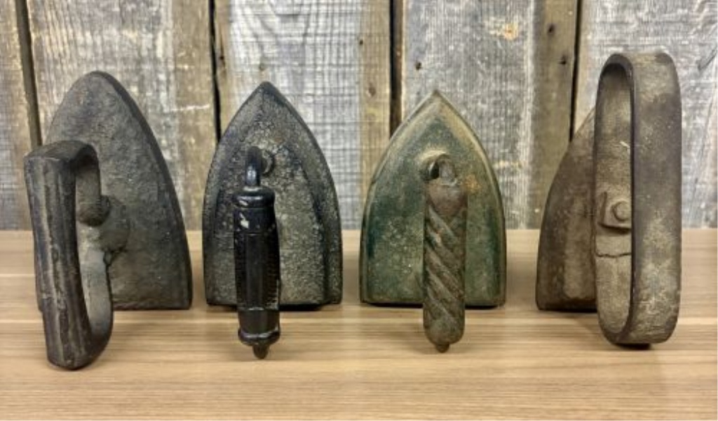 A Collection of Four Antique Cast Iron Sad Irons