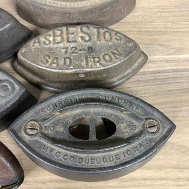 A Collection of Antique Cast Iron Asbestos and Schreiber and Conchar Sad Iron Bases and Handles