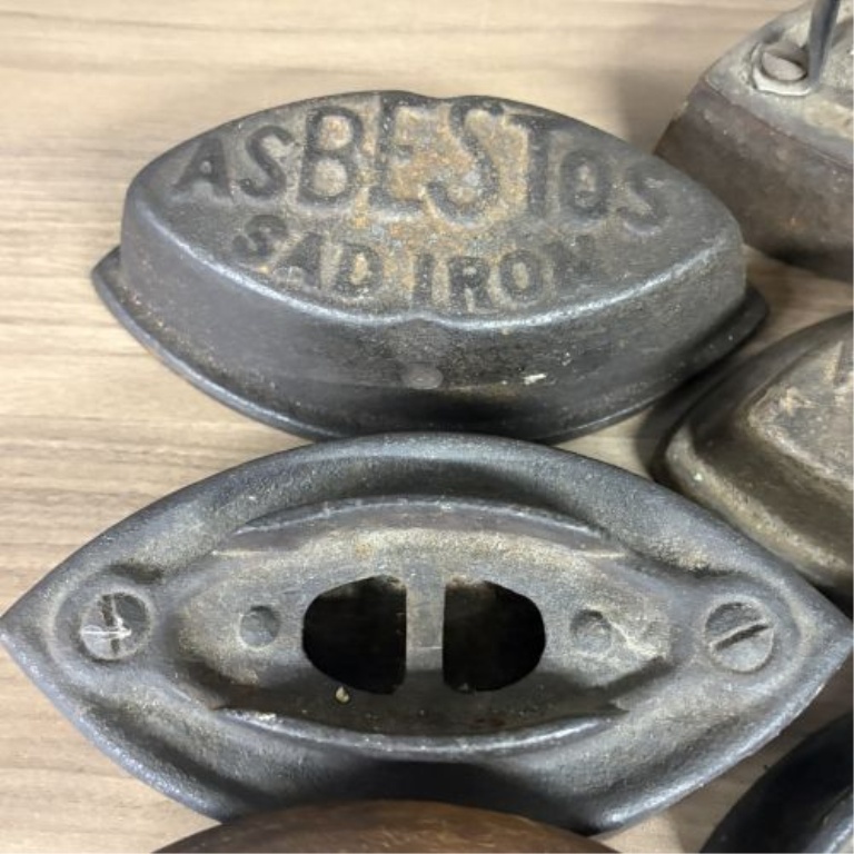 A Collection of Antique Cast Iron Asbestos and Schreiber and Conchar Sad Iron Bases and Handles