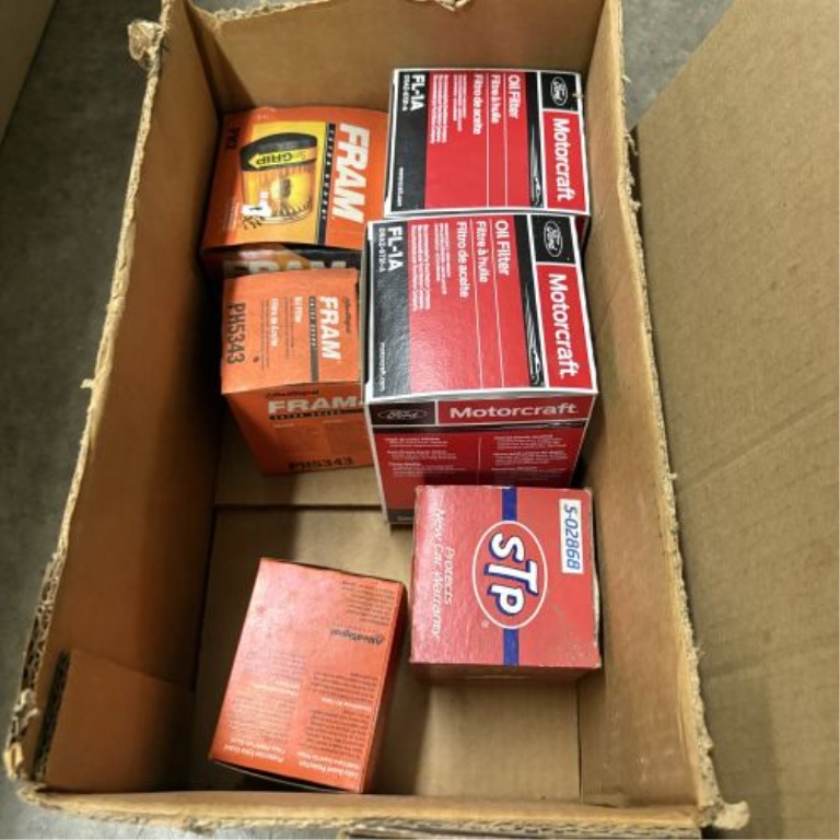 An Assortment of Automotive Maintenance Supplies, Lubricants, and Workshop Accessories