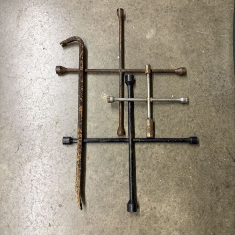An Assortment of Five Forged Steel Automotive and Demolition Tools Including Four 4-Way Lug Wrenches and One Pry Bar