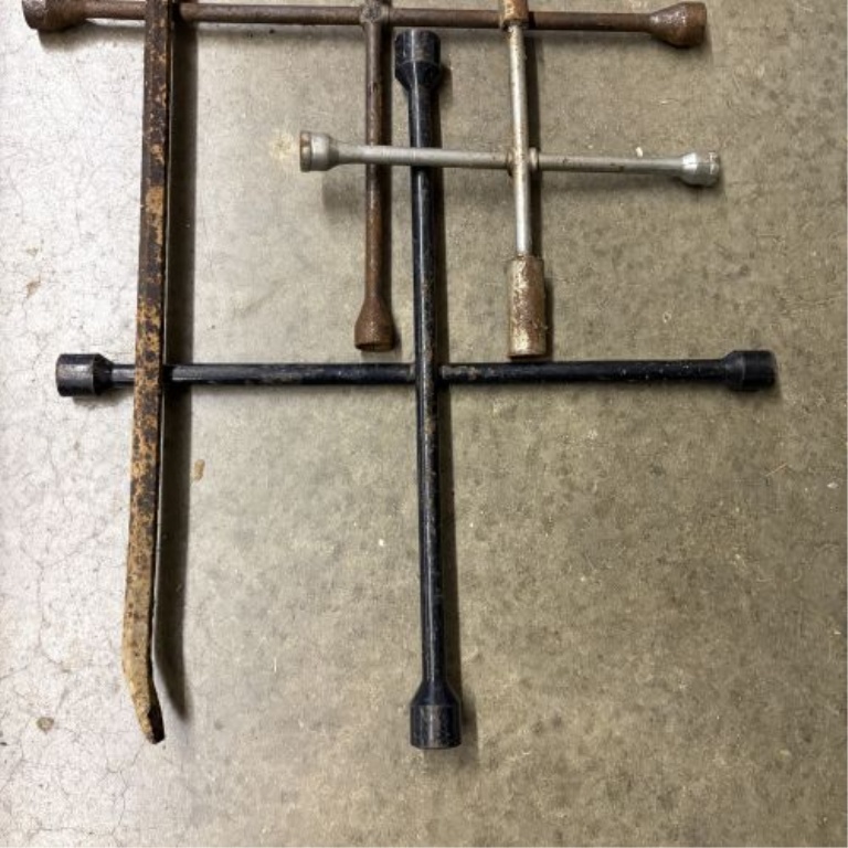 An Assortment of Five Forged Steel Automotive and Demolition Tools Including Four 4-Way Lug Wrenches and One Pry Bar