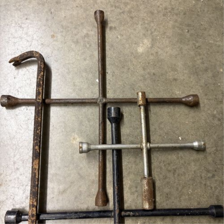 An Assortment of Five Forged Steel Automotive and Demolition Tools Including Four 4-Way Lug Wrenches and One Pry Bar