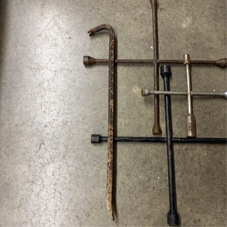 An Assortment of Five Forged Steel Automotive and Demolition Tools Including Four 4-Way Lug Wrenches and One Pry Bar
