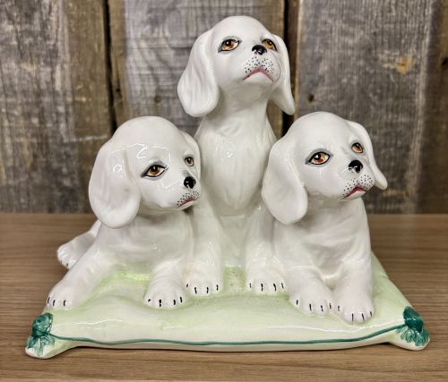 A Trio of Italian Majolica Porcelain Puppies on a Cushion