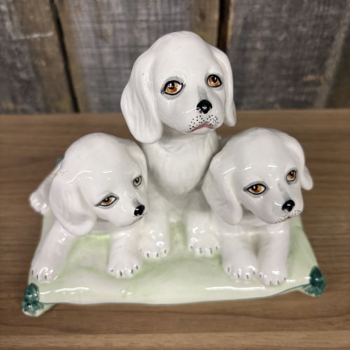 A Trio of Italian Majolica Porcelain Puppies on a Cushion