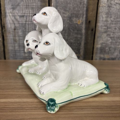 A Trio of Italian Majolica Porcelain Puppies on a Cushion