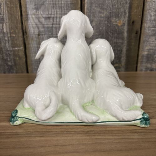 A Trio of Italian Majolica Porcelain Puppies on a Cushion