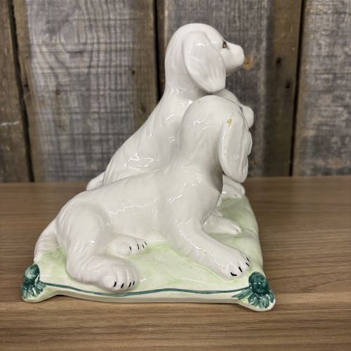 A Trio of Italian Majolica Porcelain Puppies on a Cushion