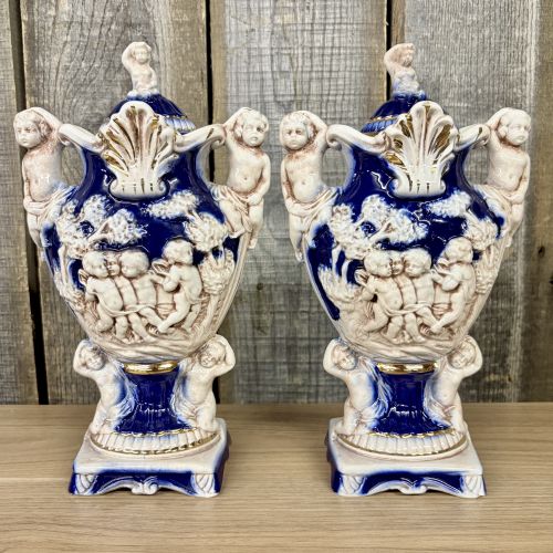 A Pair of Norleans Italy Cobalt Blue and Gilt Ceramic Lidded Urns with Cherub Relief
