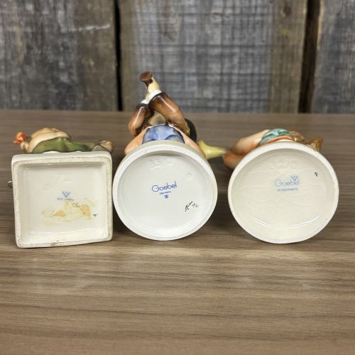 A Trio of Goebel Hummel Porcelain Figurines including Serenade, Little Gabriel, and Spring Cheer